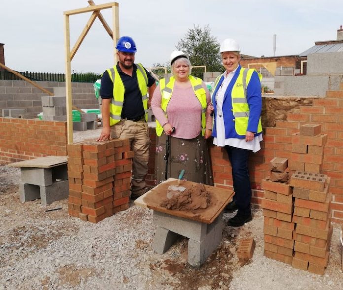 Councillor Joanne Powell-Beckett can be seen with Saul Cliff, site manager for Kettle & Talbot, and Angela Ward from The Donna Louise councillor-joanne-powell-beckett-and-site-manager-saul-cliff-andAngela-ward-from-donna-louise-trust-at-thenew-affordable-homes-building-site